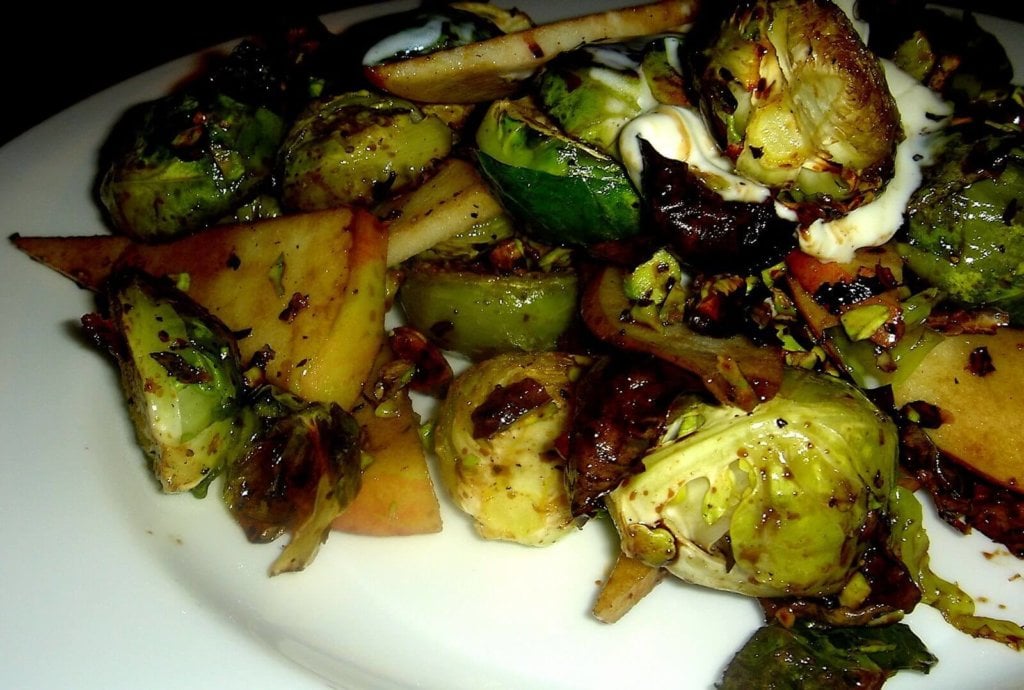 Charred Brussels sprouts, sweet apples, sour crème fraîche and toasted pistachios combine to form a delicious mixture of contrasting flavors and textures in this "Alta" tapas recreation. A balsamic vinegar reduction offers an at once sweet and sharp bite. // alexandracooks.com