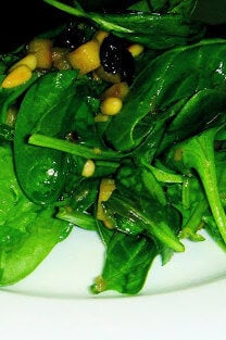 In this warm spinach salad, spinach is prepared in the classic Roman style with raisins, pine nuts and sautéed apples, but the recipe could be adjusted in any number of ways. For a nice winter side dish turn your favorite spinach salad into a warm wilted salad employing this method. It's delicious. // alexandracooks.com