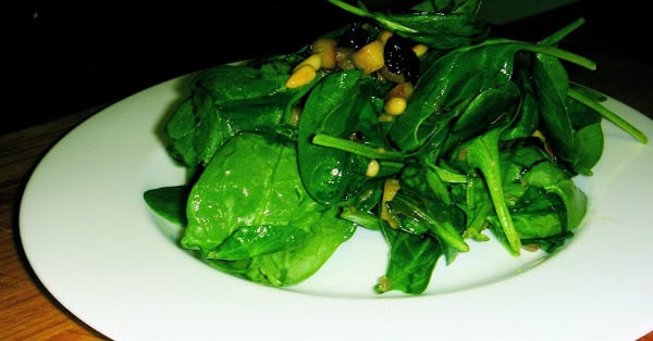 In this warm spinach salad, spinach is prepared in the classic Roman style with raisins, pine nuts and sautéed apples, but the recipe could be adjusted in any number of ways. For a nice winter side dish turn your favorite spinach salad into a warm wilted salad employing this method. It's delicious. // alexandracooks.com