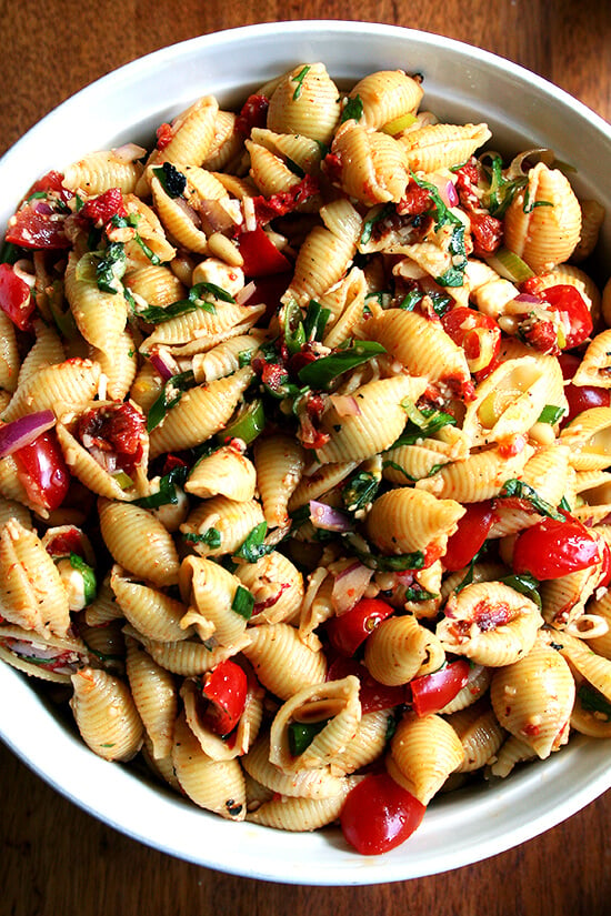 This simple pasta salad is particularly good warm, when the just-boiled shells melt the cheese, just slightly cook the tomatoes and soak up all the flavors of the olive oil and lemon juice. It can also be prepared ahead and served at room temperature — it tastes better the longer it sits in fact. // alexandracooks.com