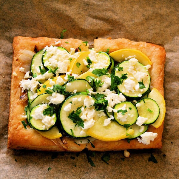 Everything about this summer squash tart is great, from the ricotta-parsley spread to the caramelized onions to the blanched squash rounds to the barely melted feta crumbled on top at the last moments of baking. // alexandracooks.com