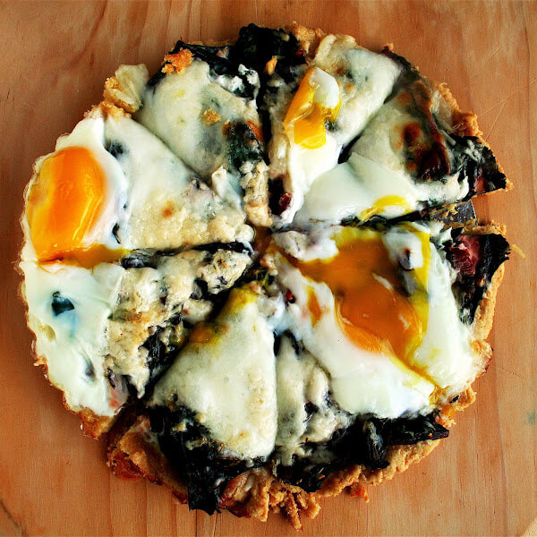 The toppings on this Swiss chard tart include sautéed chard with garlic, grated cheese, and a couple of eggs — a combination I really adore, in a buttery, cornmeal tart shell. It NEVER fails to please. // alexandracooks.com