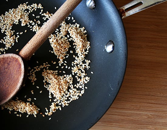 Toasted sesame seeds in a skillet.