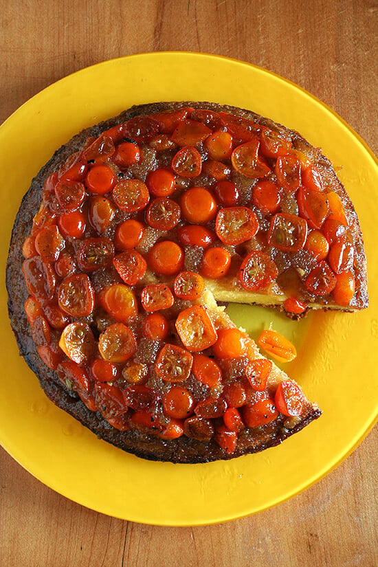 A kumquat upside down cake with a slice removed.