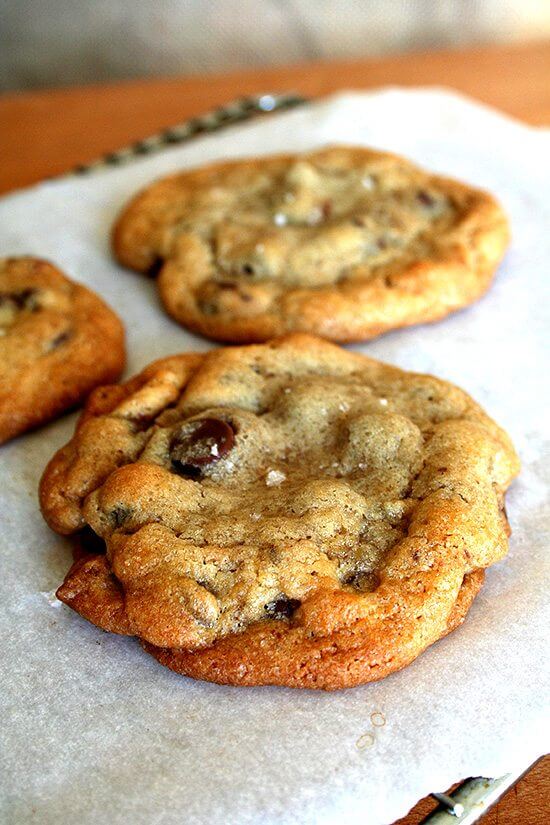 A sheet pan with freshly baked chocolate chip cookies. 