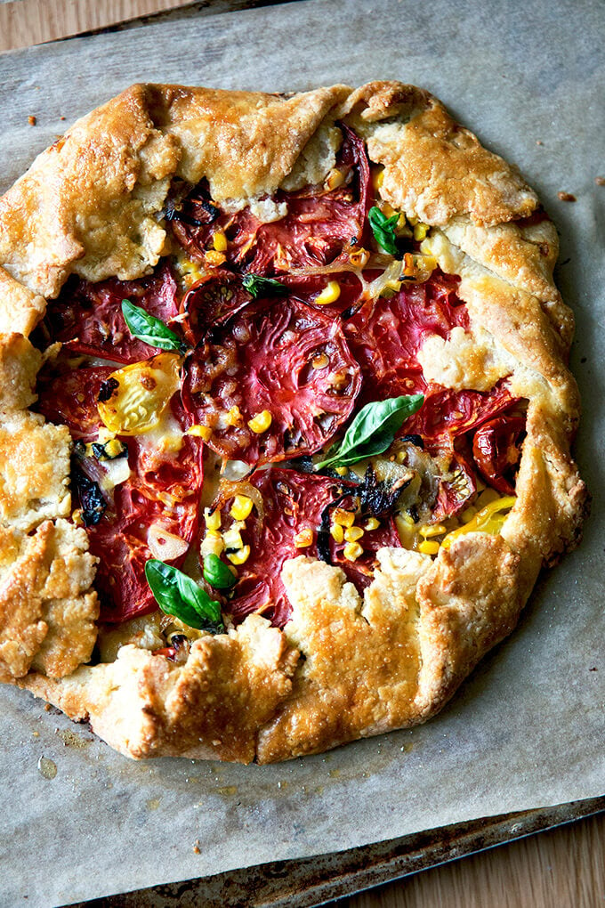 A freshly baked savory galette with corn, tomatoes, and gruyere.