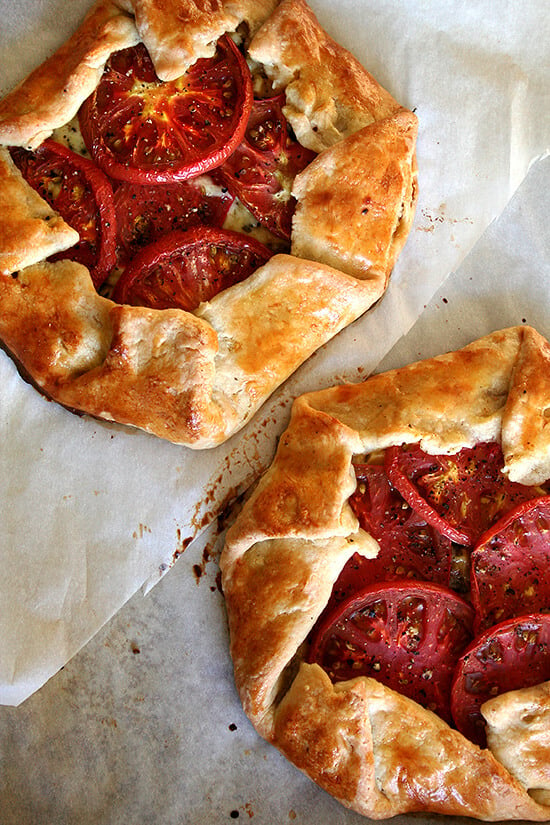 A sheet pan with two freshly baked savory galettes. 