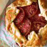 A sheet pan with two freshly baked savory galettes.