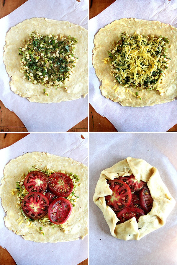 Premium Photo  Homemade galette or savory pie with red and yellow tomatoes  and basil on old newspaper or parchment paper. top view.