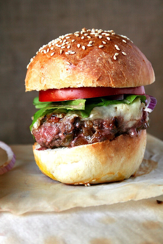 A cast iron skillet burger on a homemade hamburger bun.