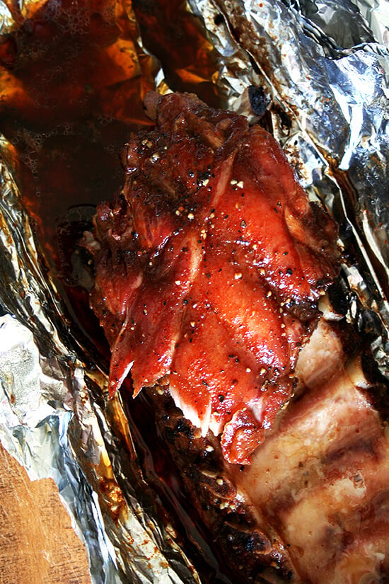 Overhead close-up of baby back ribs in tinfoil