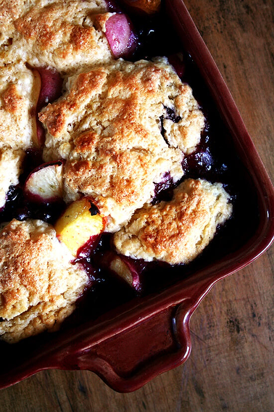 This peach blueberry cobbler is perfect for summer parties. With vanilla ice cream melting through each bite, smiles will abound. If you're needing to make a dessert for a crowd, look no further. This is it. Yum yum yum yum yum. // alexandracooks.com