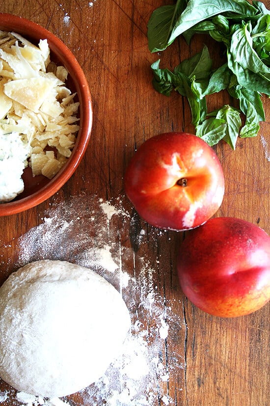 Nectarine pizza ingredients on a board. 