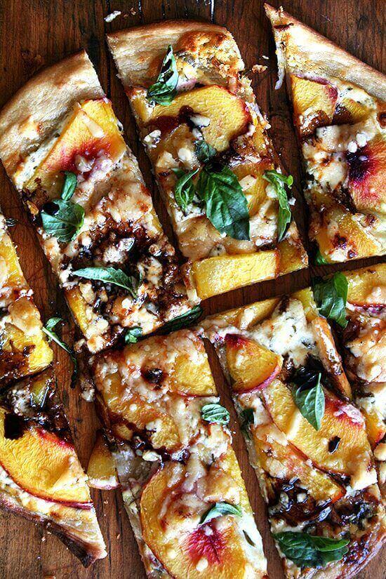 A nectarine pizza topped with blue cheese, basil, and reduced balsamic vinegar.