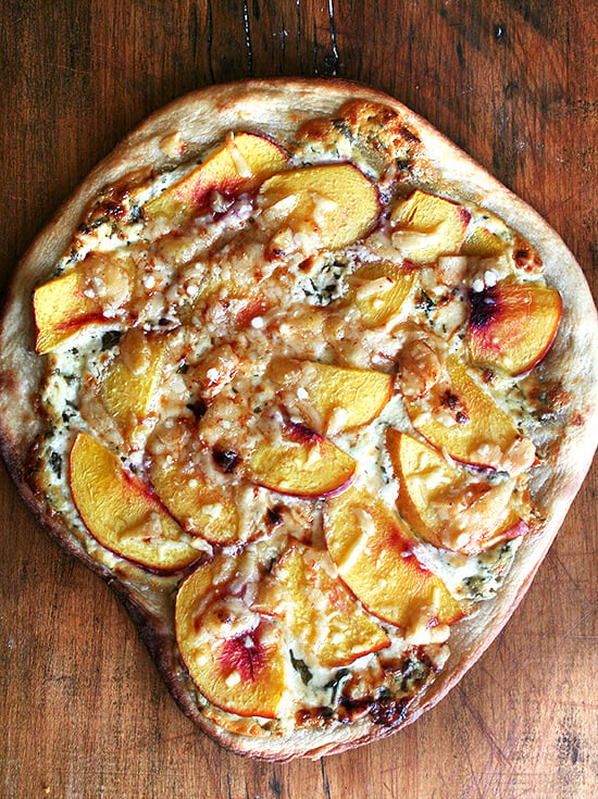 Just baked nectarine pizza on a board. 