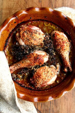 A pie dish fille with one-pot chicken with white wine, olive oil, and parmesan.