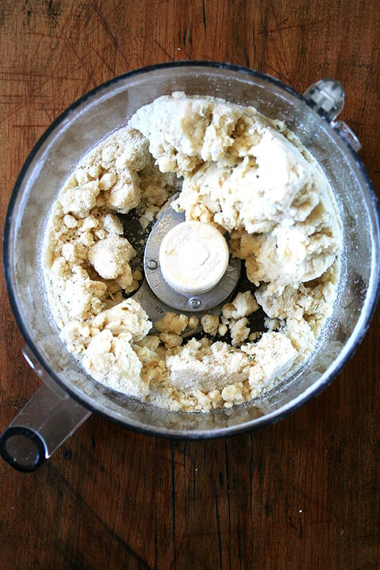 A food processor filled with the rosemary shortbread dough. 