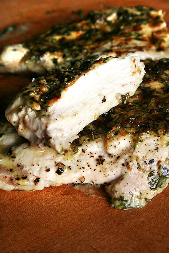 A cut broiled tarragon-mustard chicken breast.