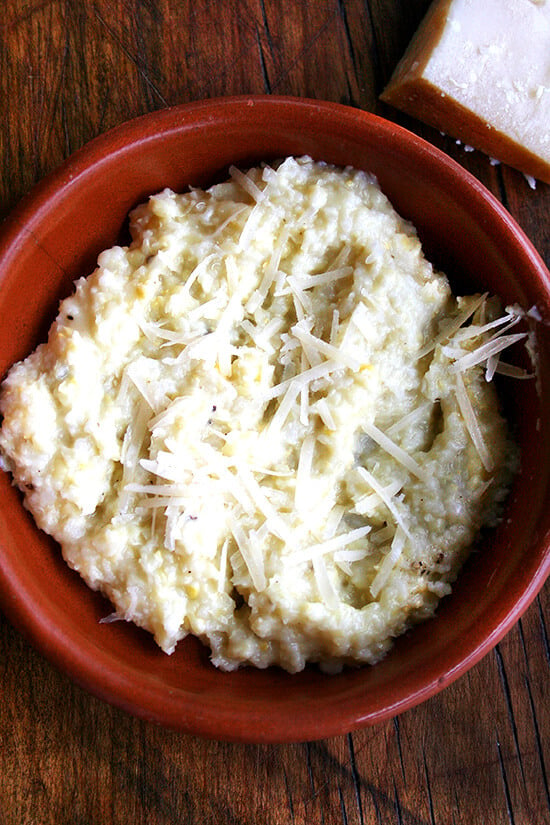 A bowl of fresh corn polenta topped with grated parmesan. 