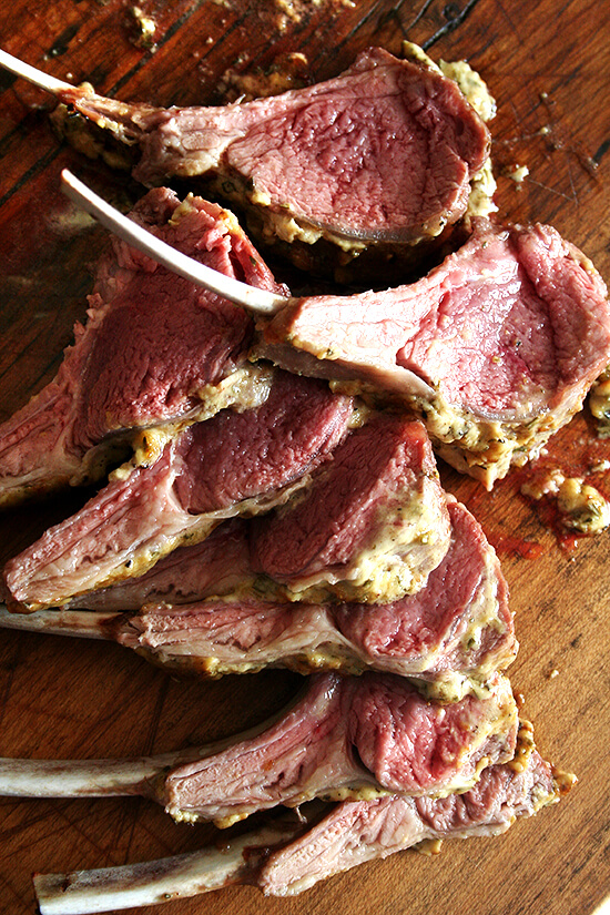 A board with sliced rack of lamb. 