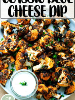 A large platter filled with buffalo cauliflower aside blue cheese dip.