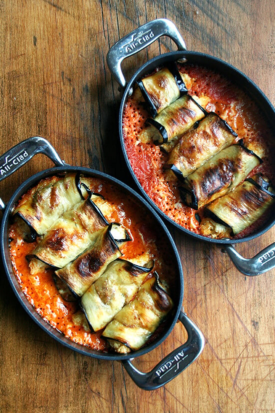 two pans of cooked eggplant involtini