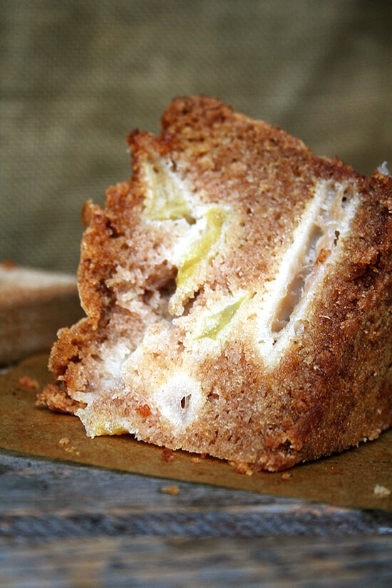 A slice of Teddie's apple cake on a board.