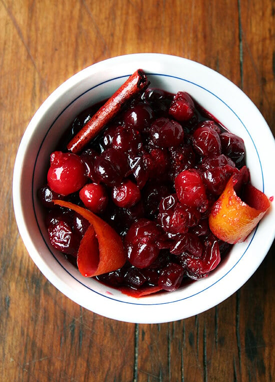 An overhead shot of a bowl holding homemade red wine cranberry sauce with orange zest and cinnamon. 