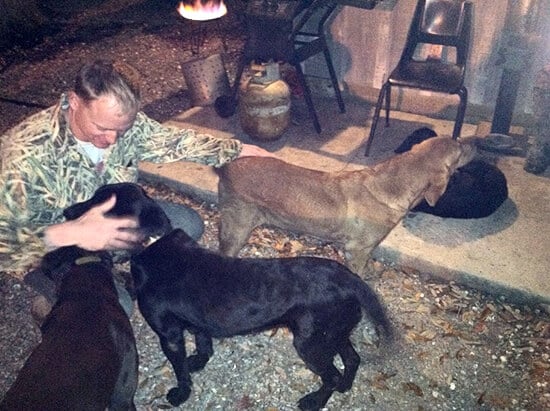 The husband, with dogs, never happier.