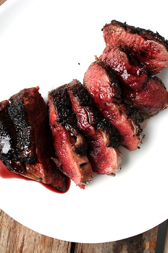 An overhead shot of a plate of seared wild duck breasts with port wine sauce. 