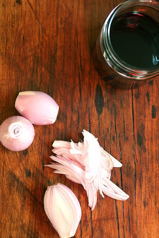 A board with shallots and port wine reduction sauce.