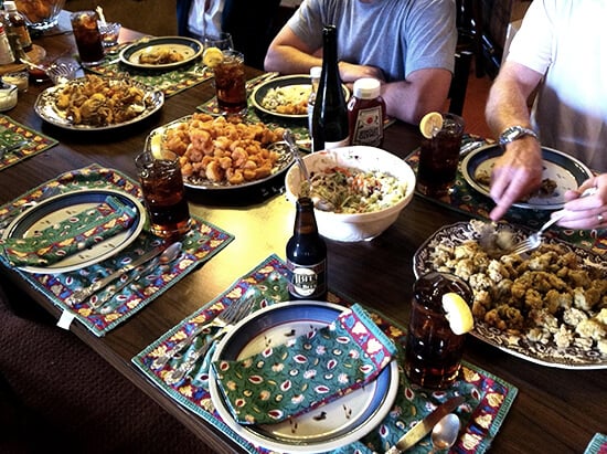 A table filled with some good southern cooking: fried oysters, fried shrimp.