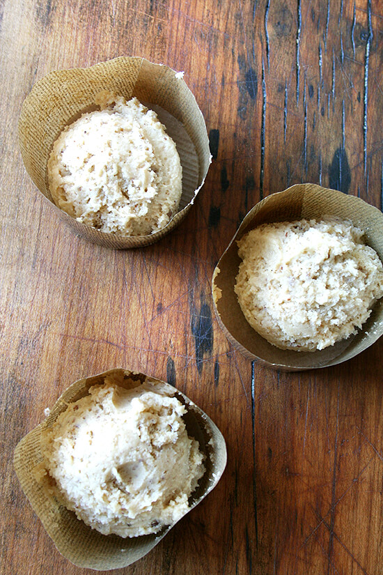 Decorative muffin liners filled with coffeecake muffin batter.