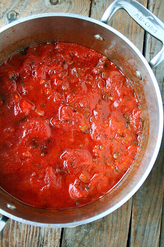 In this tomato sauce, canned tomatoes are brightened by olive oil and sautéed onions, a few cloves of crushed garlic, a little white wine, some chopped fresh parsley, and a pinch of crushed red pepper flakes. After about 20 minutes of simmering, it's done. And it's delicious. // alexandracooks.com