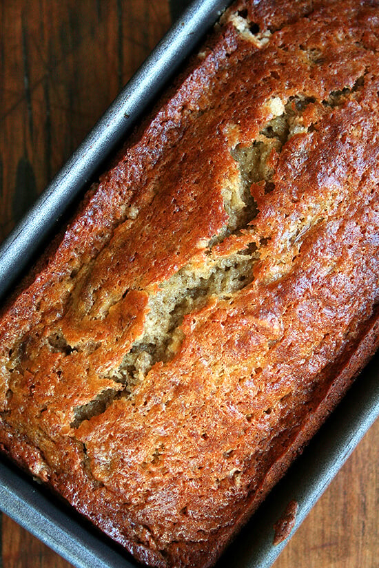 Close-up overhead view of moist banana bread loaf in baking pan.