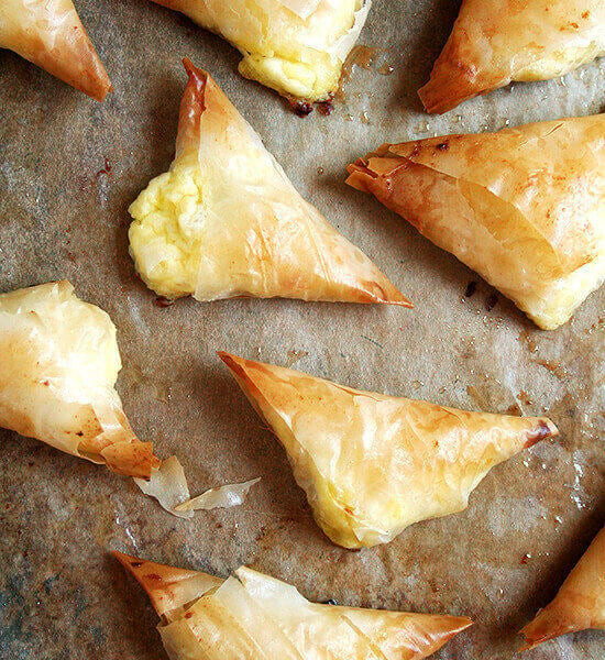 Just-baked tiropitas on a sheet pan.