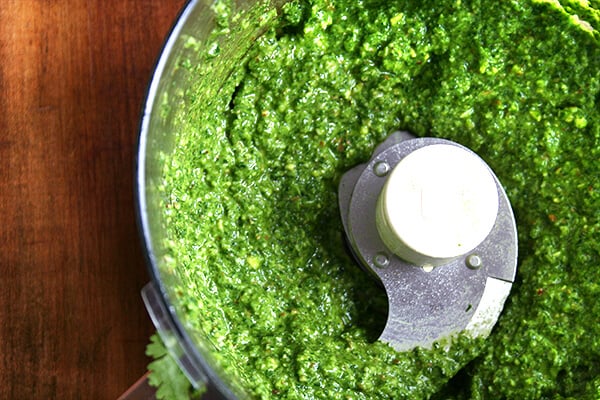 Food processo with pesto sauce puréed. 