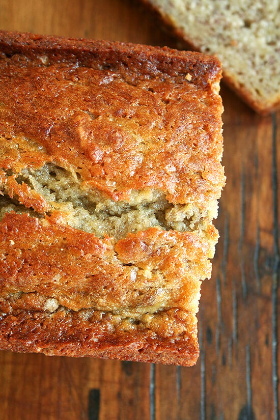 Close-up of sliced, moist banana bread on cutting board