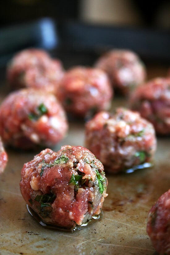 Formed unbaked meatballs. 