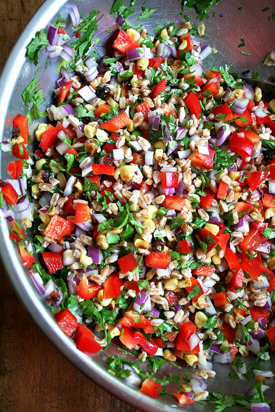 This farro salad, a combination of roasted corn, fresh-squeezed lime juice, cilantro, minced chili peppers and diced peppers and onions, has become a weekly staple. If you strategize by chopping the vegetables and herbs while the corn is roasting and the farro is simmering, this salad can come together in just about 20 minutes. It yields a lot, thanks to all of the add-ins, and tastes better with each passing day. // alexandracooks.com