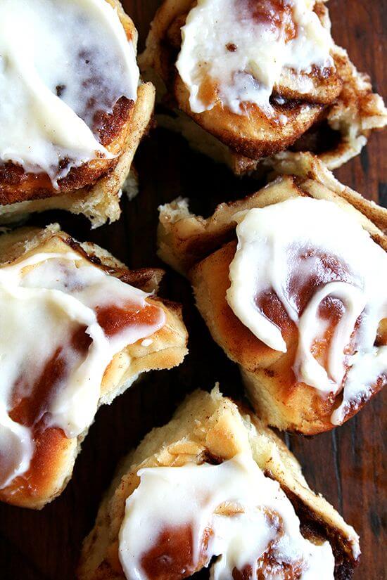 Overhead shot of iced cinnamon rolls on a table.