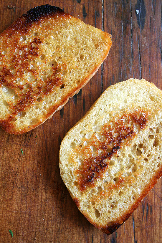 This amazing recipe for a classic grilled cheese sandwich calls for crisping country white bread slices in a skillet on one side before topping them with cheese and sautéed shallots. The open-faced halves finish cooking in the oven before being pressed together into a traditional sandwich. This simple technique produces such a brilliant result: perfectly golden bread flanking perfectly melty cheese. // alexandracooks.com