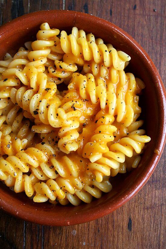 A bowl of pasta with butternut squash pasta sauce.