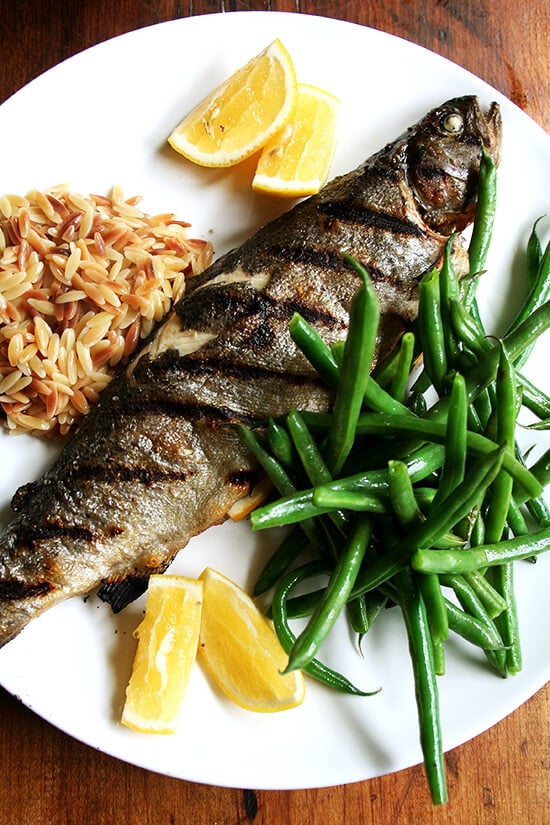 Whole grilled trout with green beans and orzo