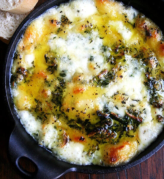 Baked fontina with rosemary and thyme in a cast iron skillet.