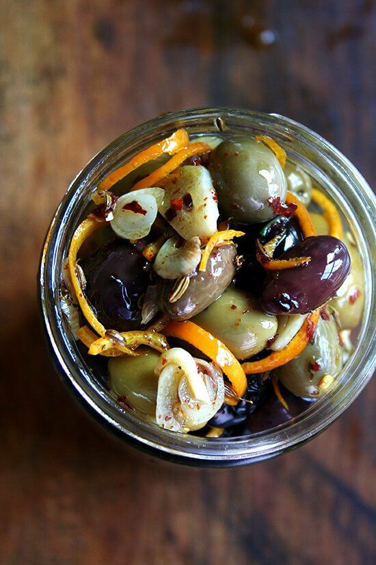 Marinated olives are about as easy as it gets as far as sprucing up the hors d'oeuvres spread goes — a little garlic and orange zest along with a few spices (crushed red pepper flakes and fennel seed) go a long way, and these flavor elements look so pretty in the serving dish as well. // alexandracooks.com