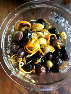 Marinated olives are about as easy as it gets as far as sprucing up the hors d'oeuvres spread goes — a little garlic and orange zest along with a few spices (crushed red pepper flakes and fennel seed) go a long way, and these flavor elements look so pretty in the serving dish as well. // alexandracooks.com