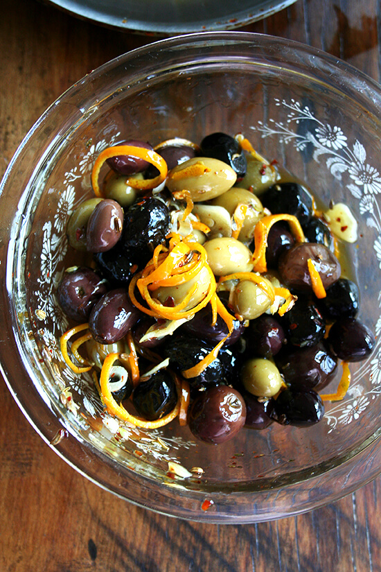 Marinated olives are about as easy as it gets as far as sprucing up the hors d'oeuvres spread goes — a little garlic and orange zest along with a few spices (crushed red pepper flakes and fennel seed) go a long way, and these flavor elements look so pretty in the serving dish as well. // alexandracooks.com