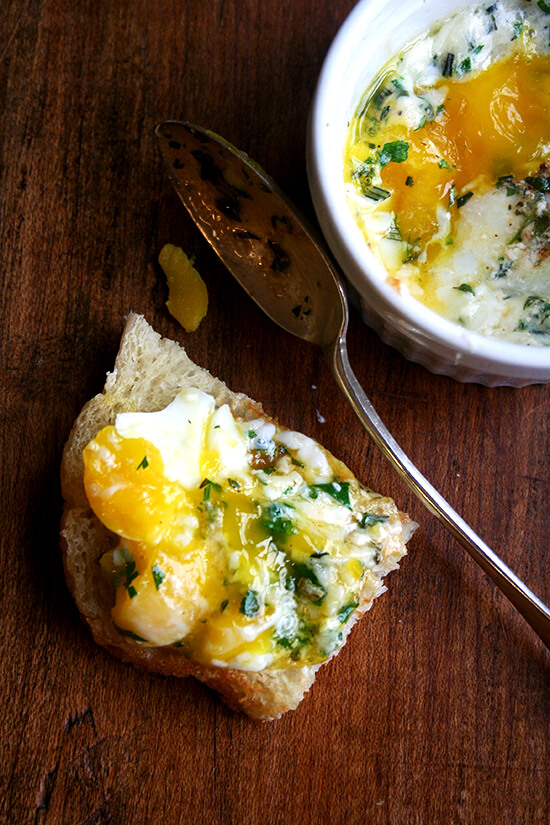 A piece of toast topped with baked (shirred) eggs.
