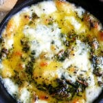 A cast iron skillet filled with baked fontina.